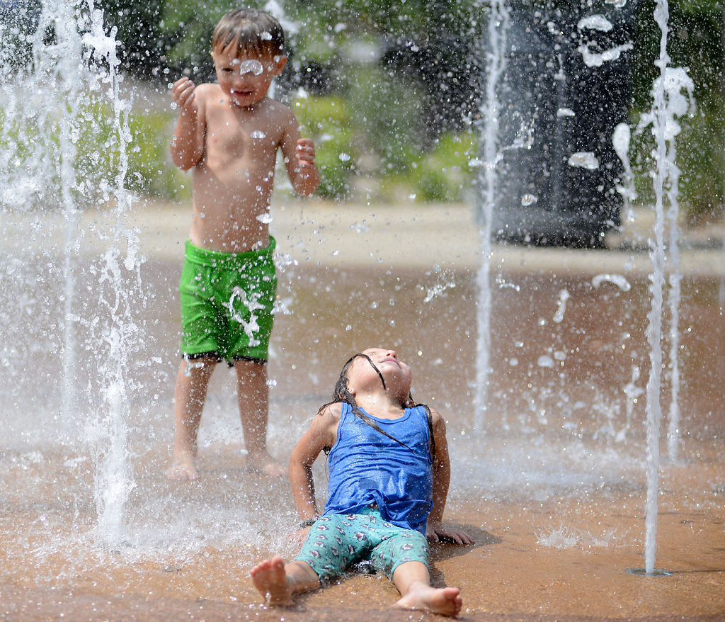 Phoenix Boss, 4, and his sister ,Prudence Boss, 5, play at Chamber Centennial Fountain